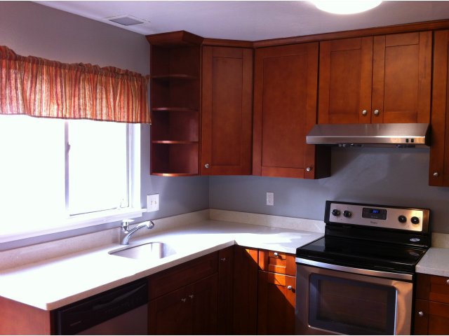 1231 Terra Nova Boulevard Pacifica, CA 94044 - Photo 4 of 18 a kitchen with a sink a stove cabinets and wooden floor