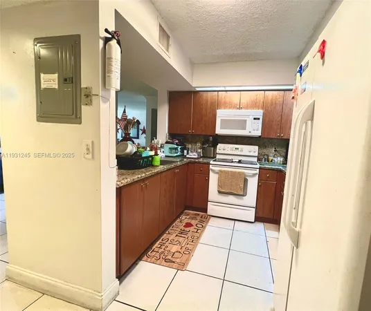 a kitchen with a refrigerator and a stove