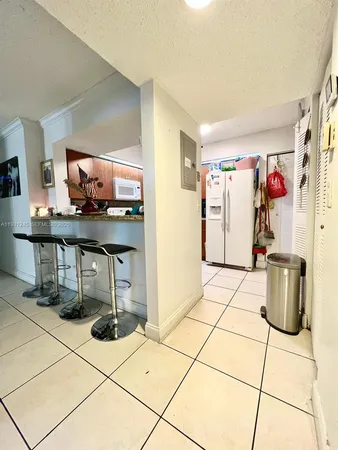 a living room with furniture a flat screen tv and a table