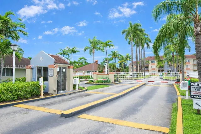 a row of palm trees and swimming pool in the backyard of a house