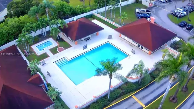 an aerial view of a house with a garden and swimming pool