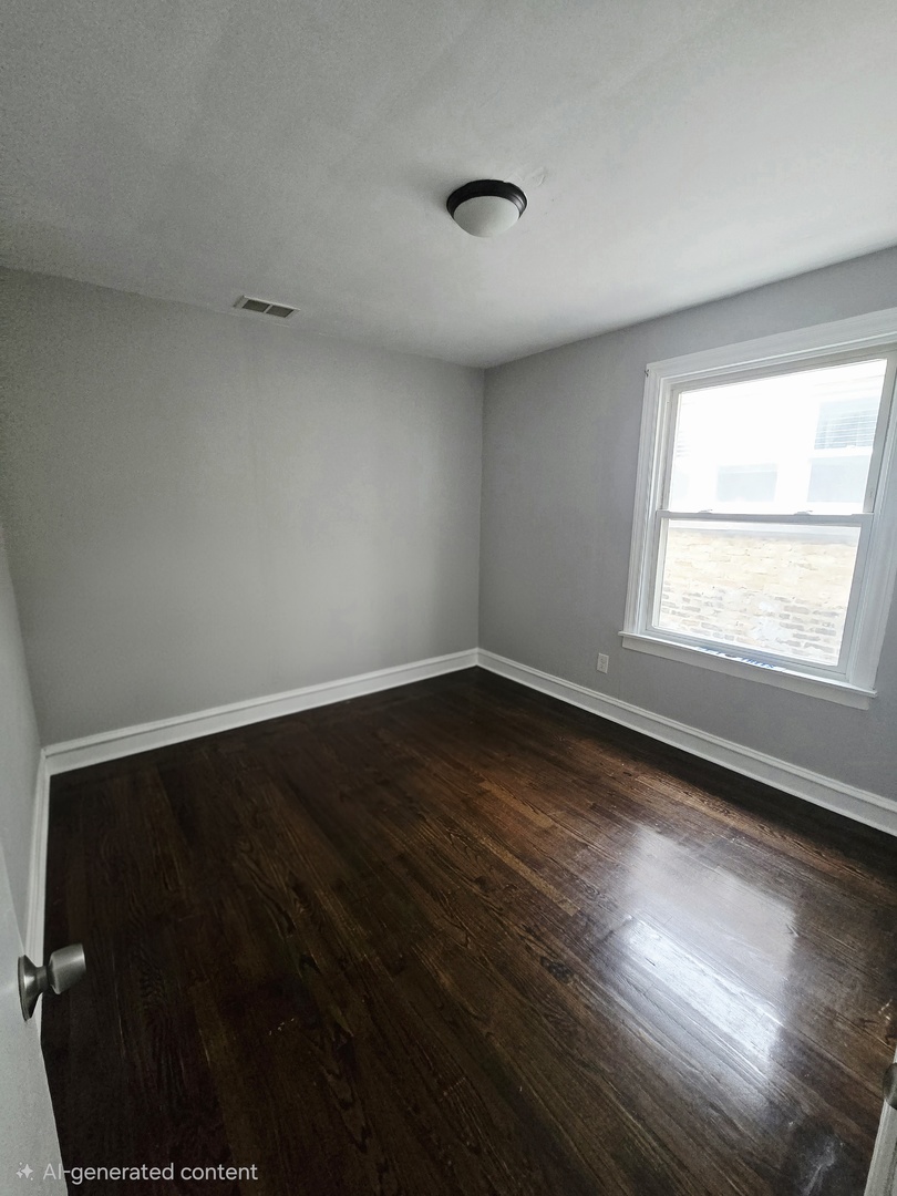4819 West George Street, Unit 2 Chicago, IL 60641 - Photo 4 of 9 wooden floor in an empty room
