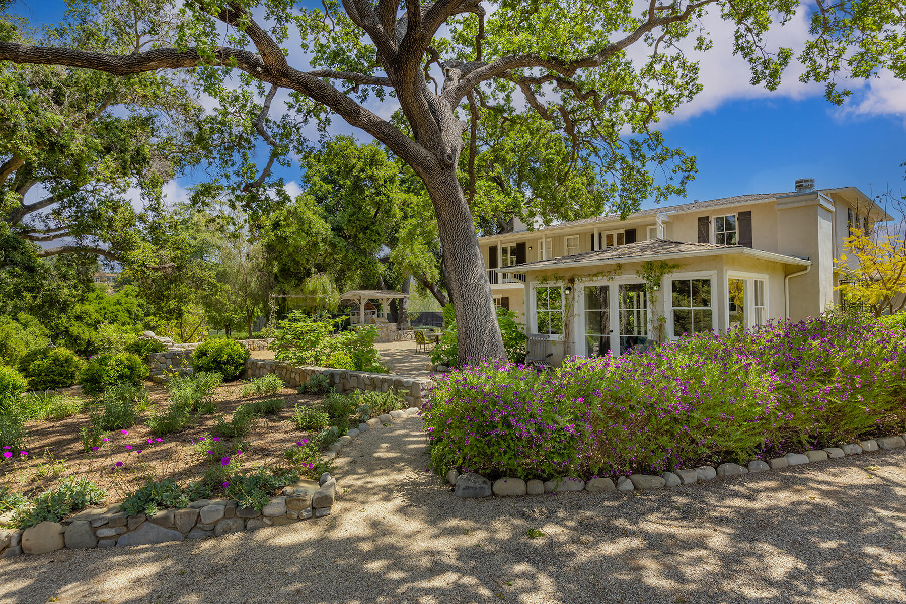a front view of a house with a garden