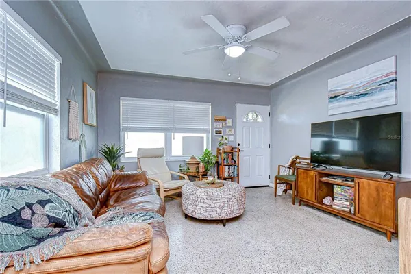 a living room with furniture and a flat screen tv