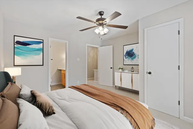 a bedroom with a large bed and a chandelier