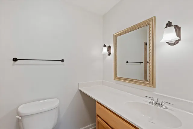a bathroom with a sink toilet and vanity
