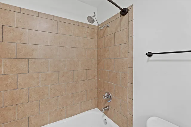 a bathroom with a shower and a toilet