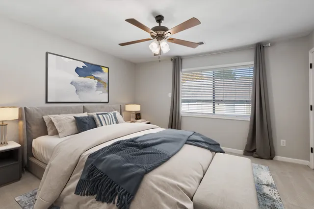 a bedroom with a large bed and a window