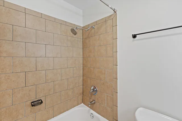 a bathroom with a shower and toilet
