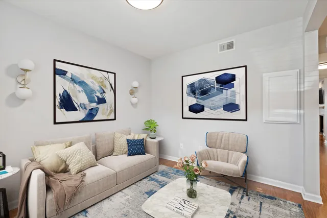 a living room with furniture and a painting on the wall
