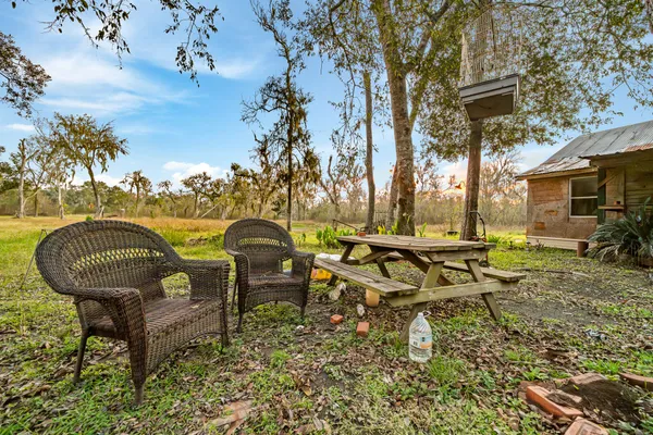 a view of a house with yard and sitting area
