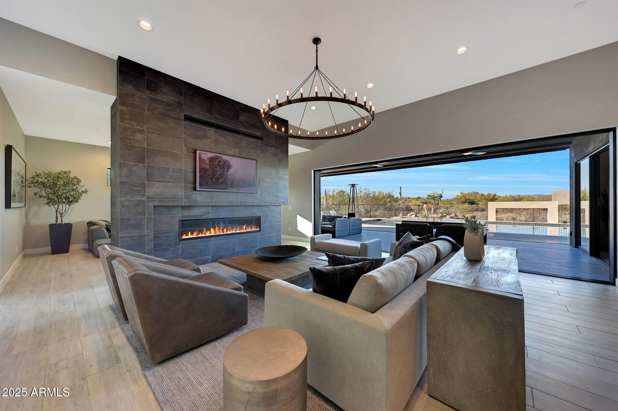 13018 East Juan Tabo Road Scottsdale, AZ 85255 - Photo 11 of 72 a living room with furniture a fireplace and a flat screen tv