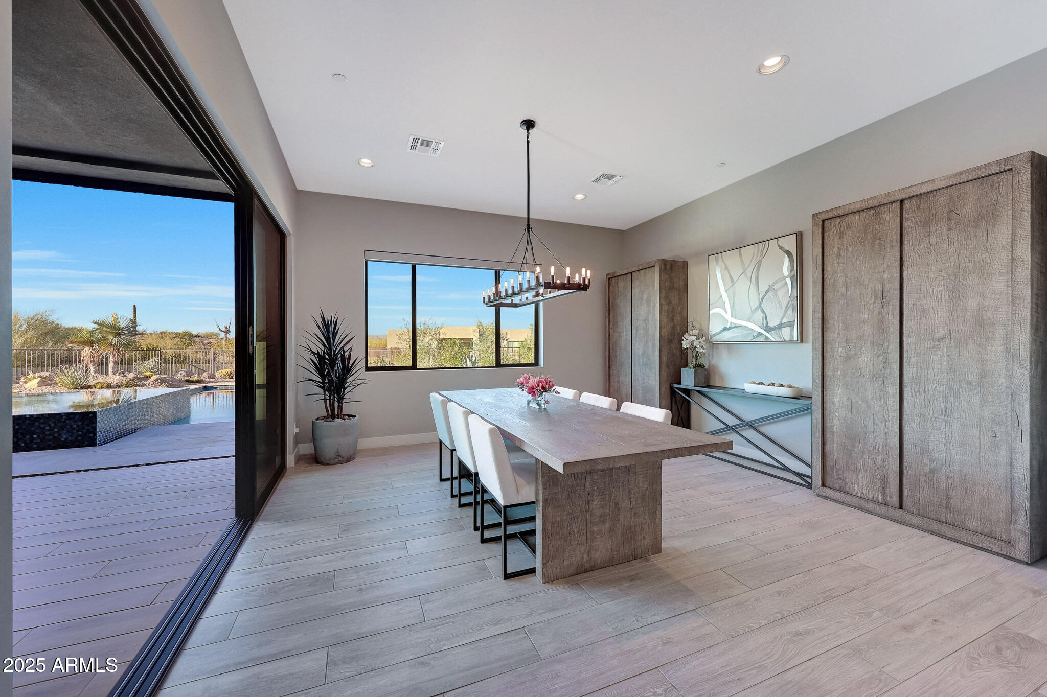 13018 East Juan Tabo Road Scottsdale, AZ 85255 - Photo 13 of 72 a dining hall with stainless steel appliances granite countertop a refrigerator a sink a dining table and chairs with wooden floor