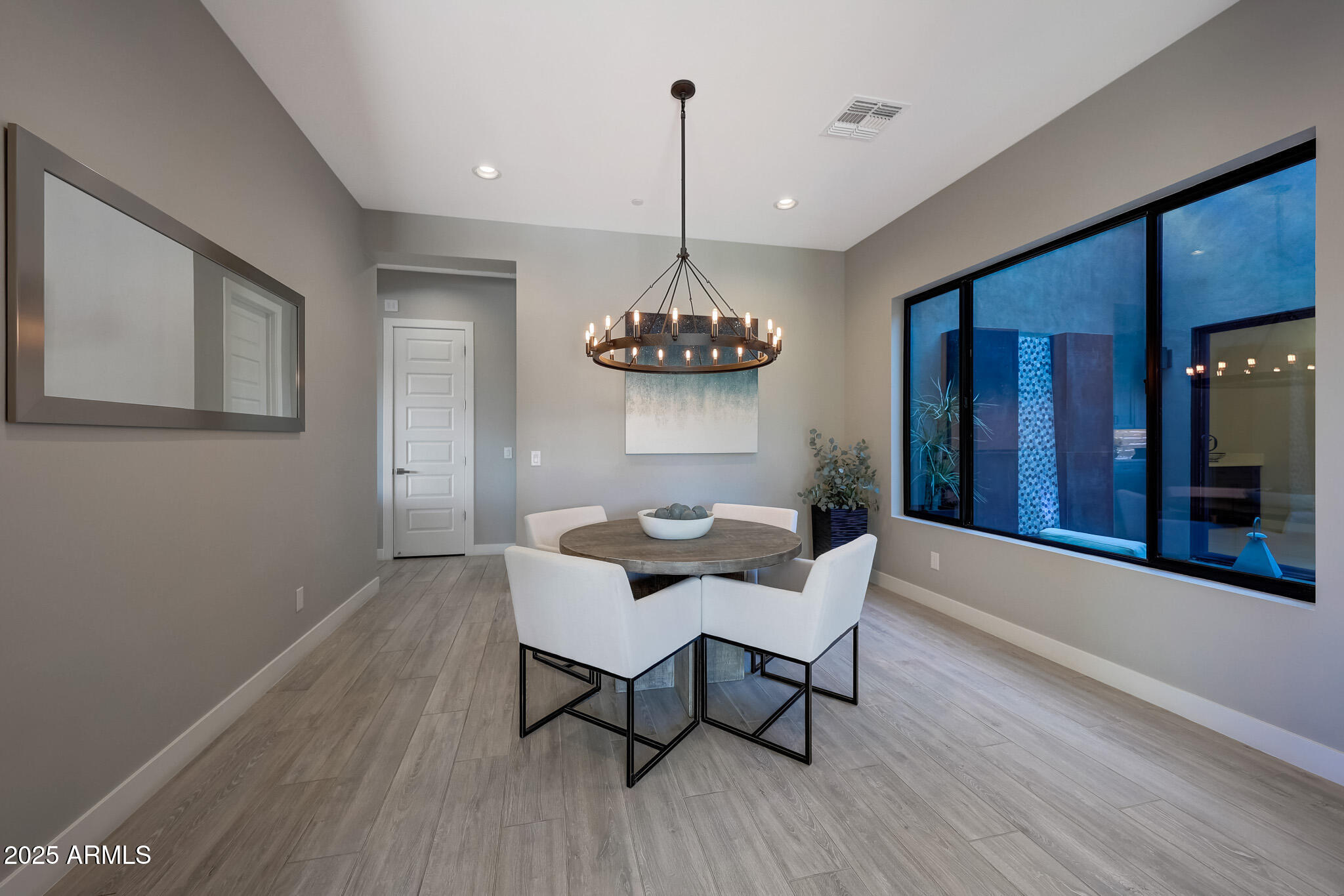 13018 East Juan Tabo Road Scottsdale, AZ 85255 - Photo 16 of 72 a view of a dining room with furniture wooden floor and chandelier