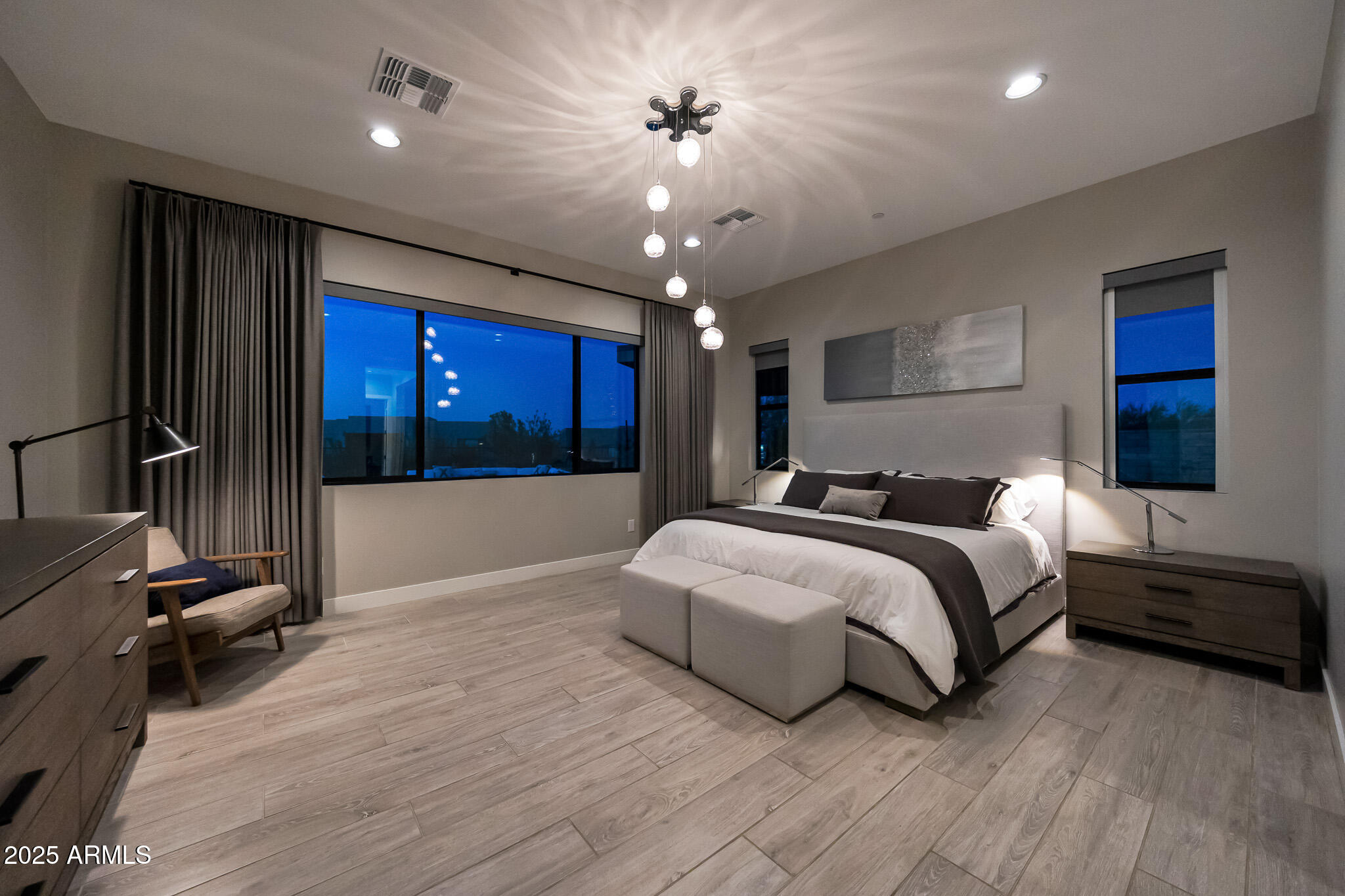13018 East Juan Tabo Road Scottsdale, AZ 85255 - Photo 22 of 72 a spacious bedroom with a large bed and a chandelier