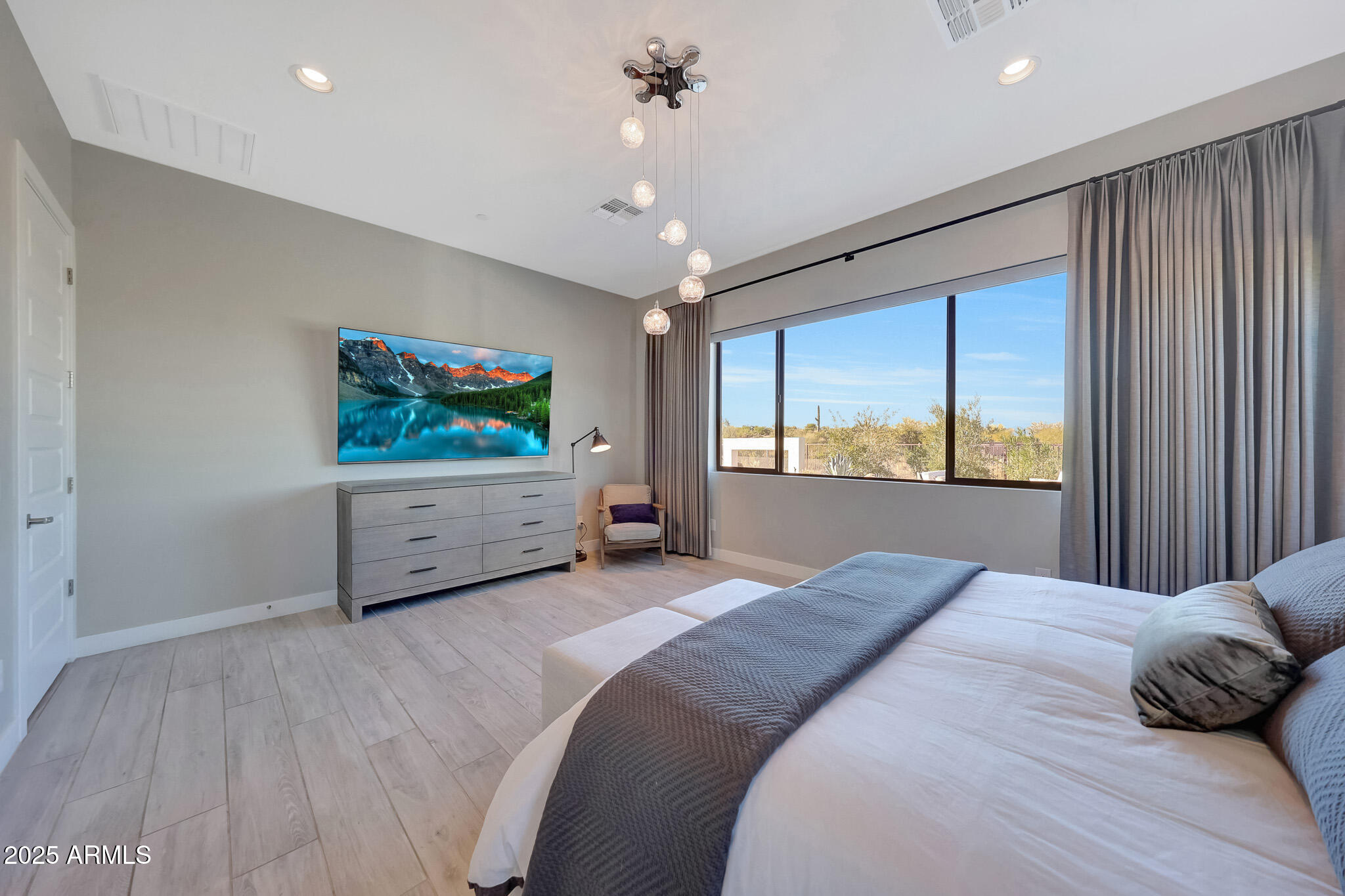 13018 East Juan Tabo Road Scottsdale, AZ 85255 - Photo 23 of 72 a bedroom with a large bed and a flat screen tv