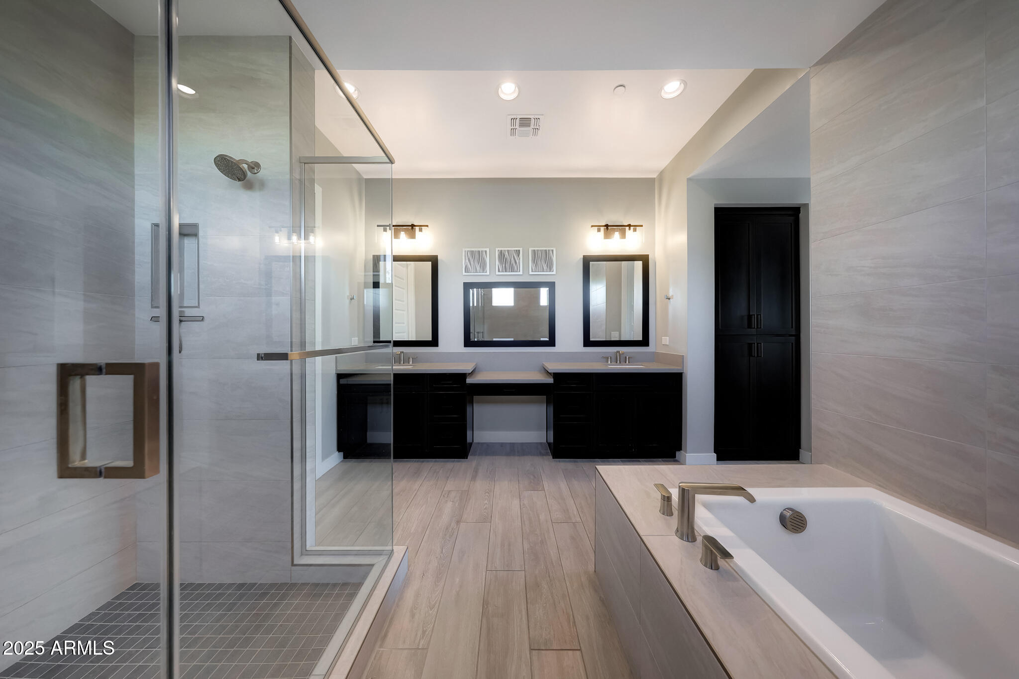 13018 East Juan Tabo Road Scottsdale, AZ 85255 - Photo 27 of 72 a bathroom with a tub a double vanity sink and a mirror