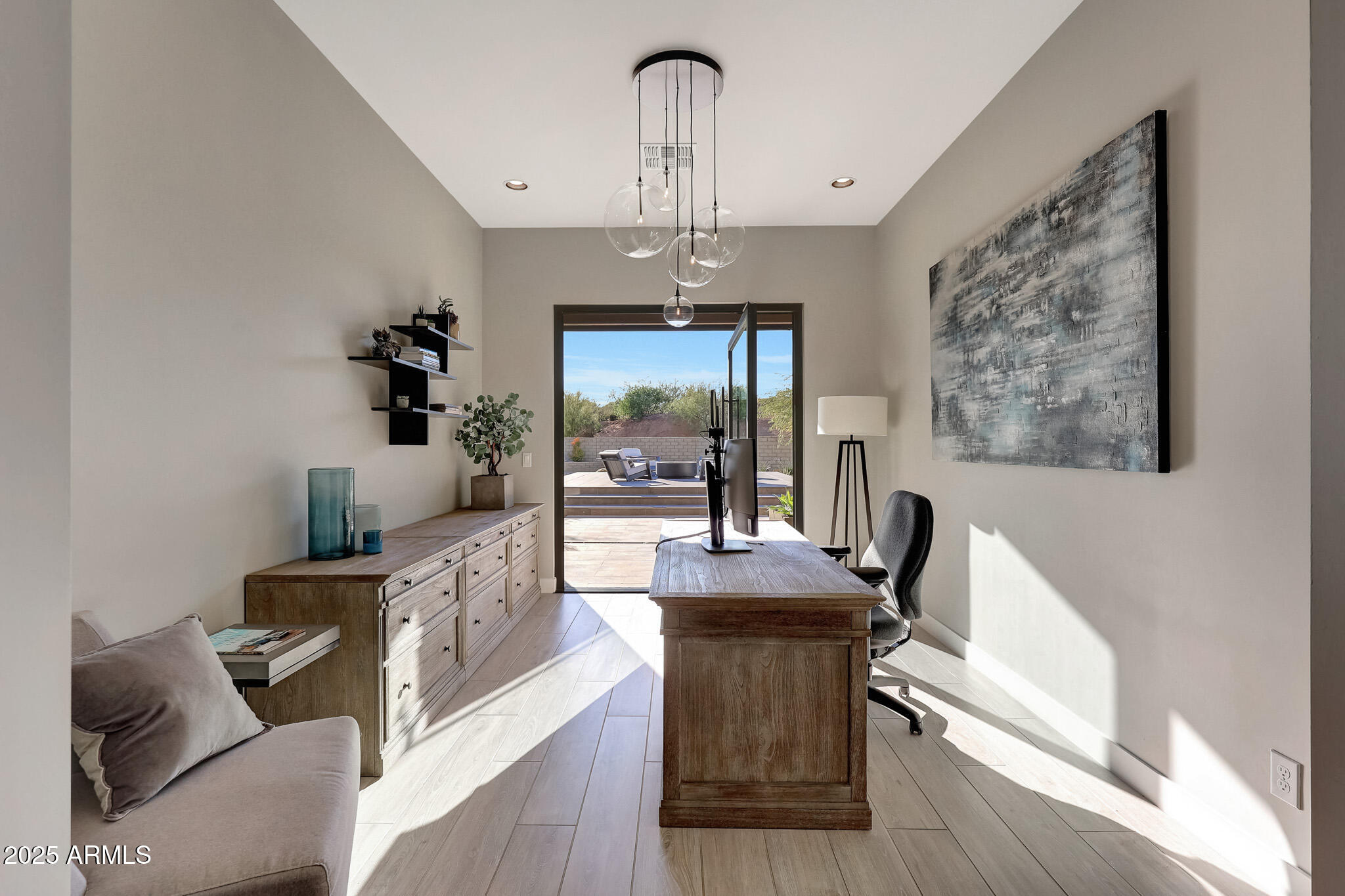 13018 East Juan Tabo Road Scottsdale, AZ 85255 - Photo 29 of 72 a living room with furniture and a chandelier