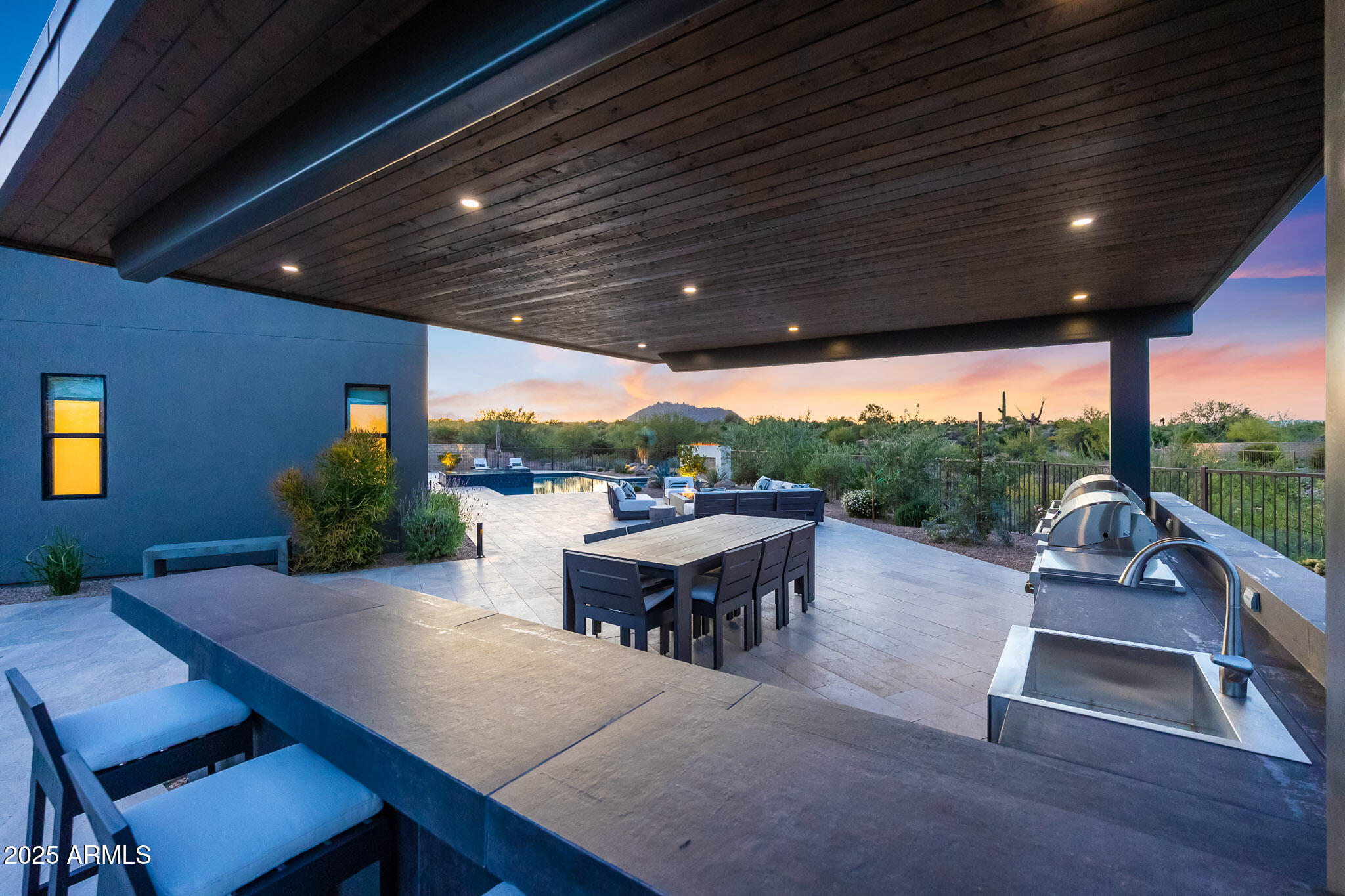 13018 East Juan Tabo Road Scottsdale, AZ 85255 - Photo 57 of 72 a view of a patio with table and chairs with wooden floor and fence
