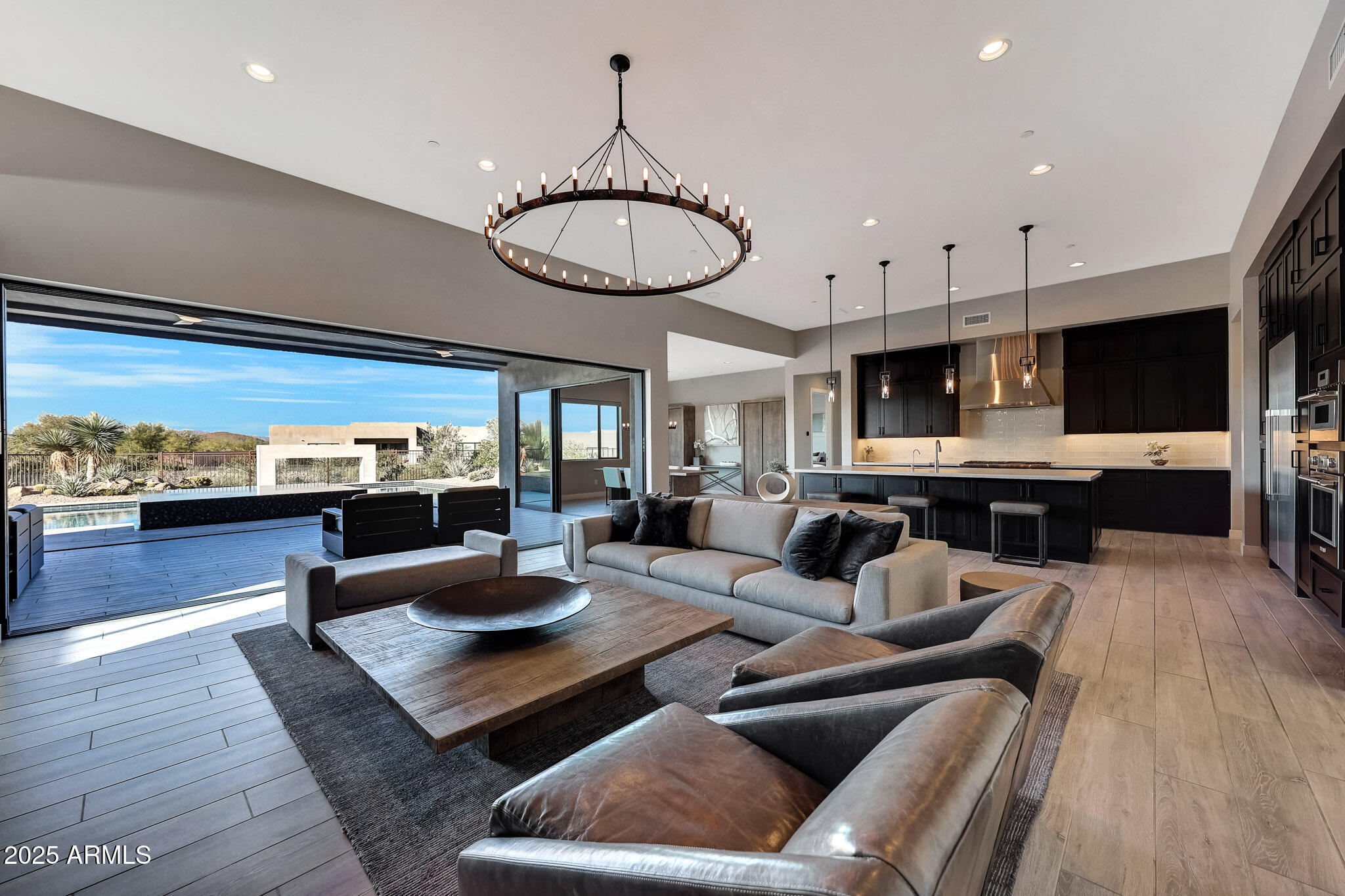 13018 East Juan Tabo Road Scottsdale, AZ 85255 - Photo 10 of 72 a living room with furniture a fireplace and kitchen view