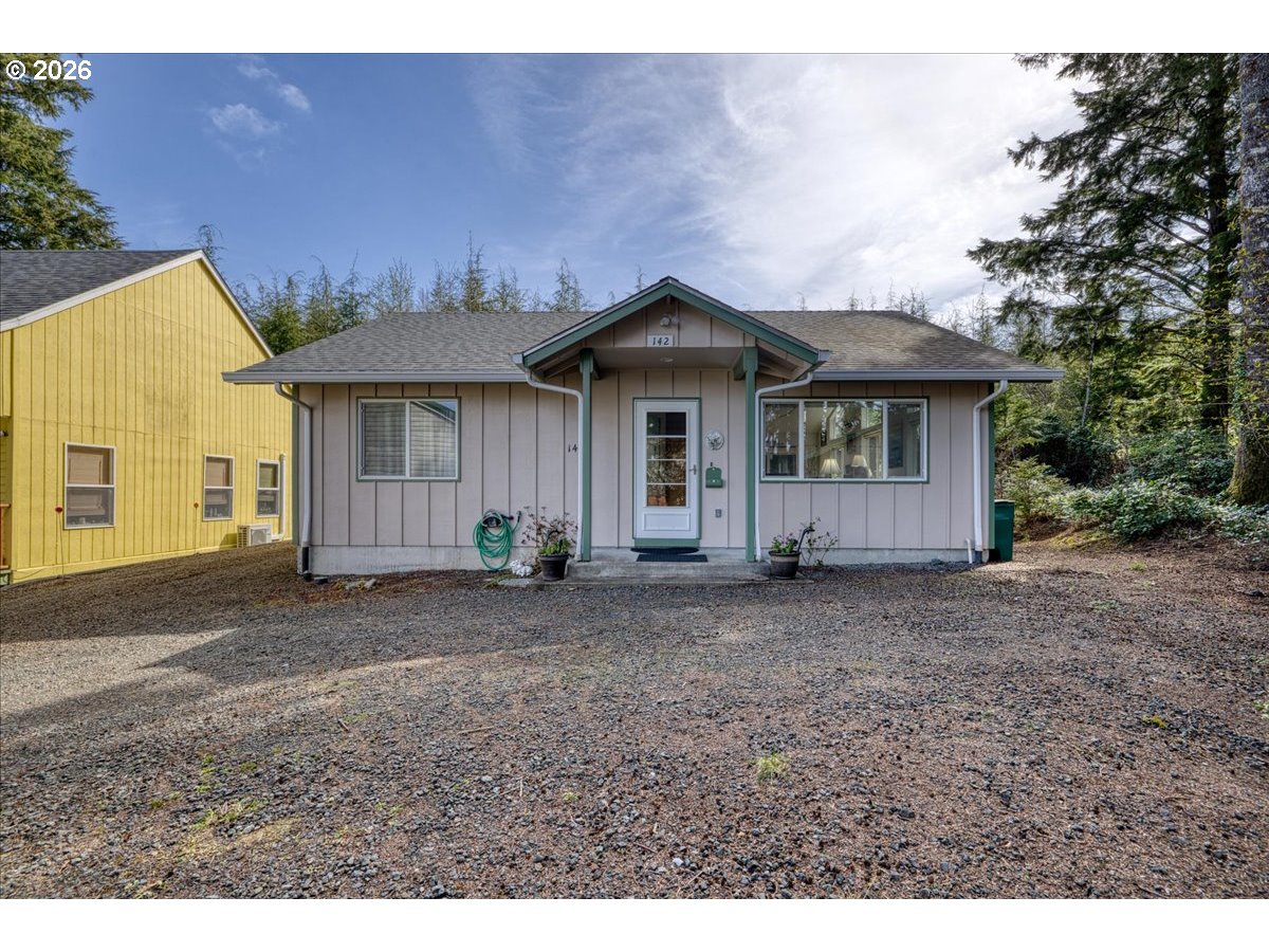 142 South Quadrant Street Rockaway Beach, OR 97136 - Photo 1 of 42 a view of a house with a yard and garage
