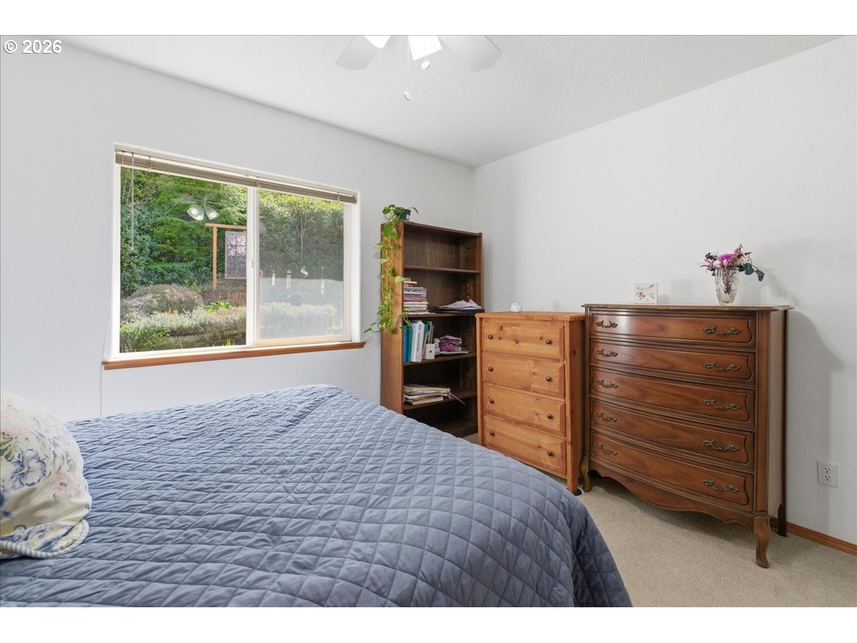 142 South Quadrant Street Rockaway Beach, OR 97136 - Photo 14 of 42 a bed room with a bed and a television