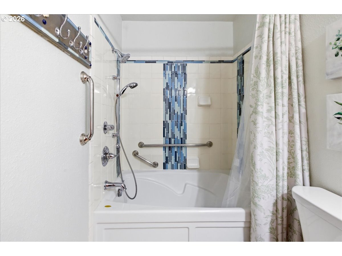 142 South Quadrant Street Rockaway Beach, OR 97136 - Photo 18 of 42 a bathroom with a shower and a sink
