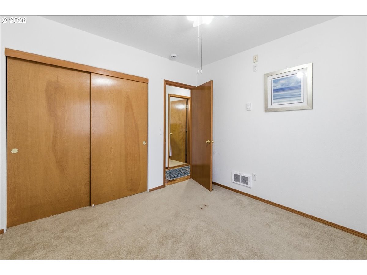 142 South Quadrant Street Rockaway Beach, OR 97136 - Photo 21 of 42 a view of an empty room with window and closet