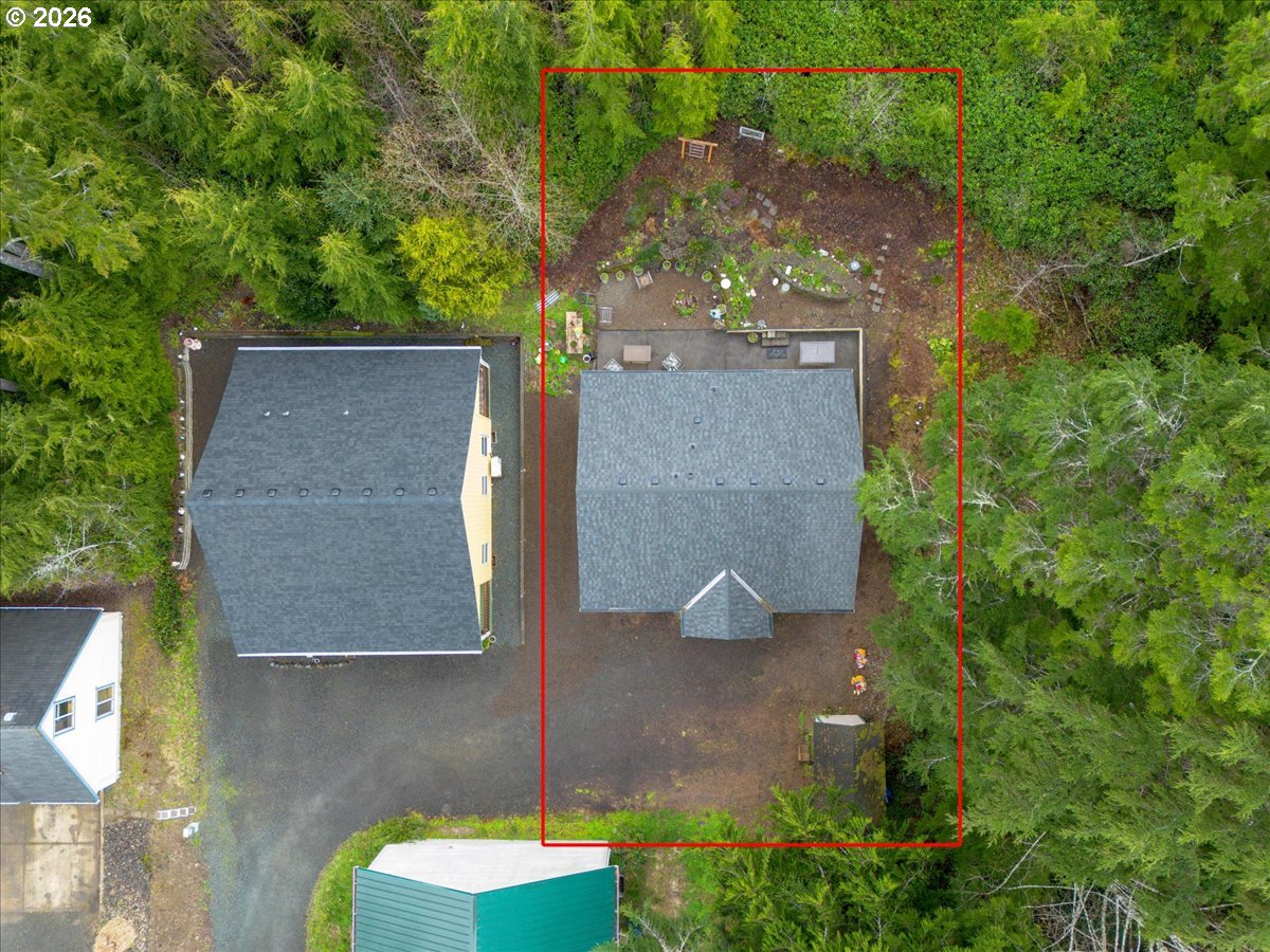 142 South Quadrant Street Rockaway Beach, OR 97136 - Photo 3 of 42 an aerial view of a house with a yard