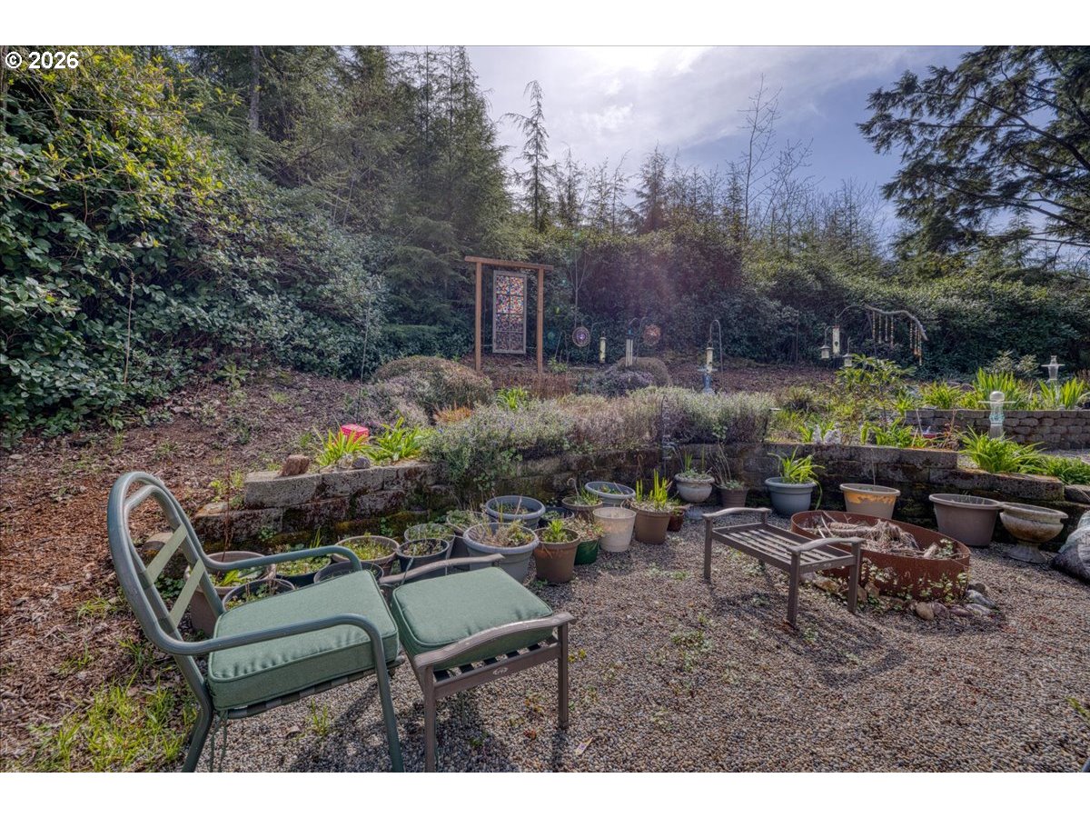 142 South Quadrant Street Rockaway Beach, OR 97136 - Photo 34 of 42 a backyard of a house with table and chairs