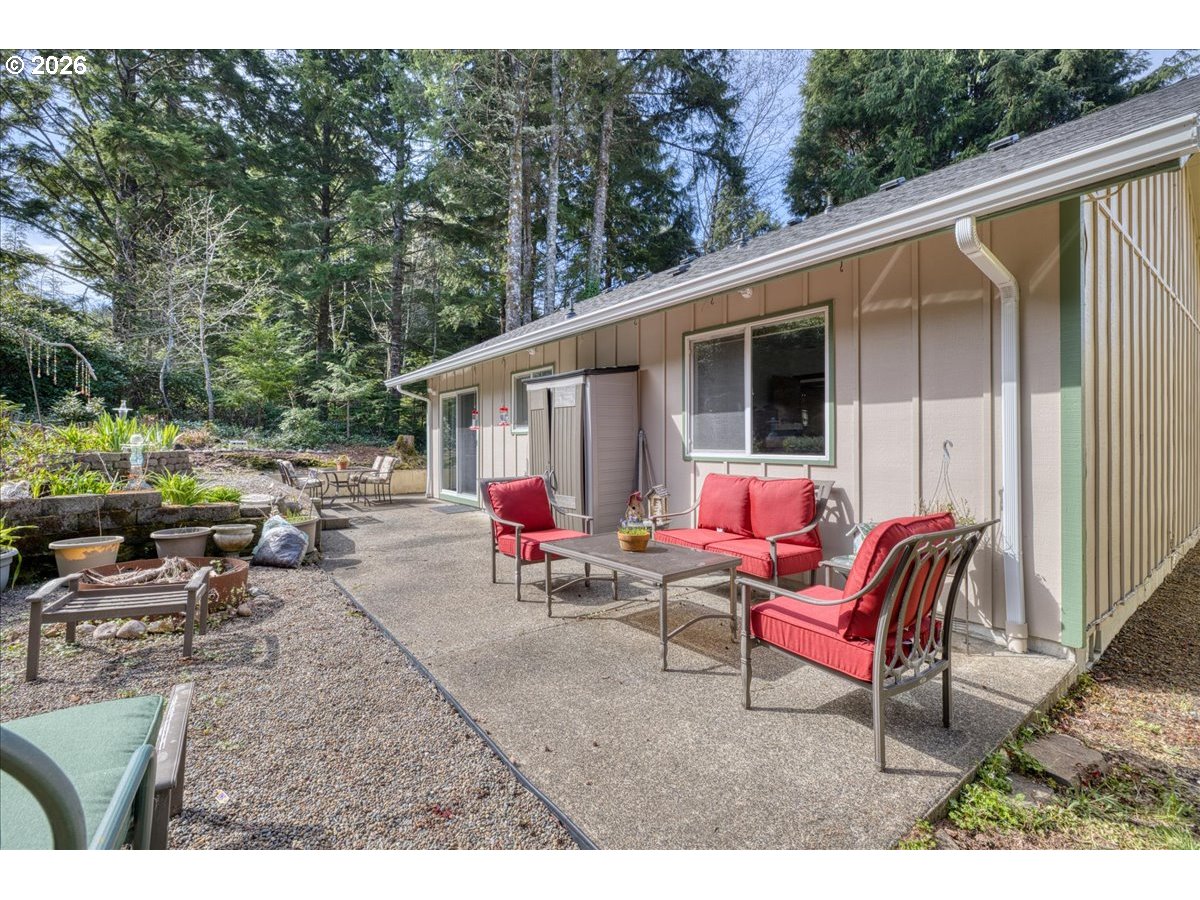 142 South Quadrant Street Rockaway Beach, OR 97136 - Photo 35 of 42 a backyard of a house with a table and chairs