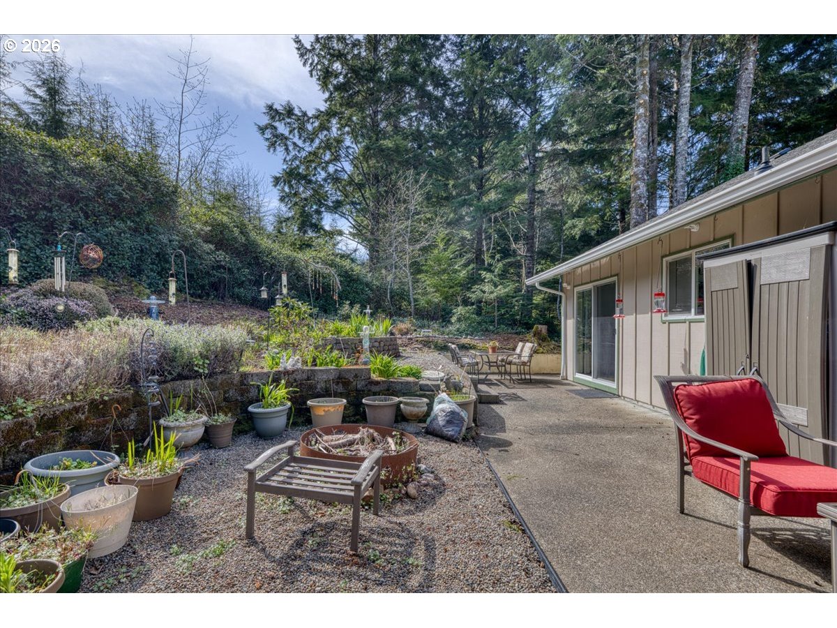 142 South Quadrant Street Rockaway Beach, OR 97136 - Photo 36 of 42 a backyard of a house with outdoor seating