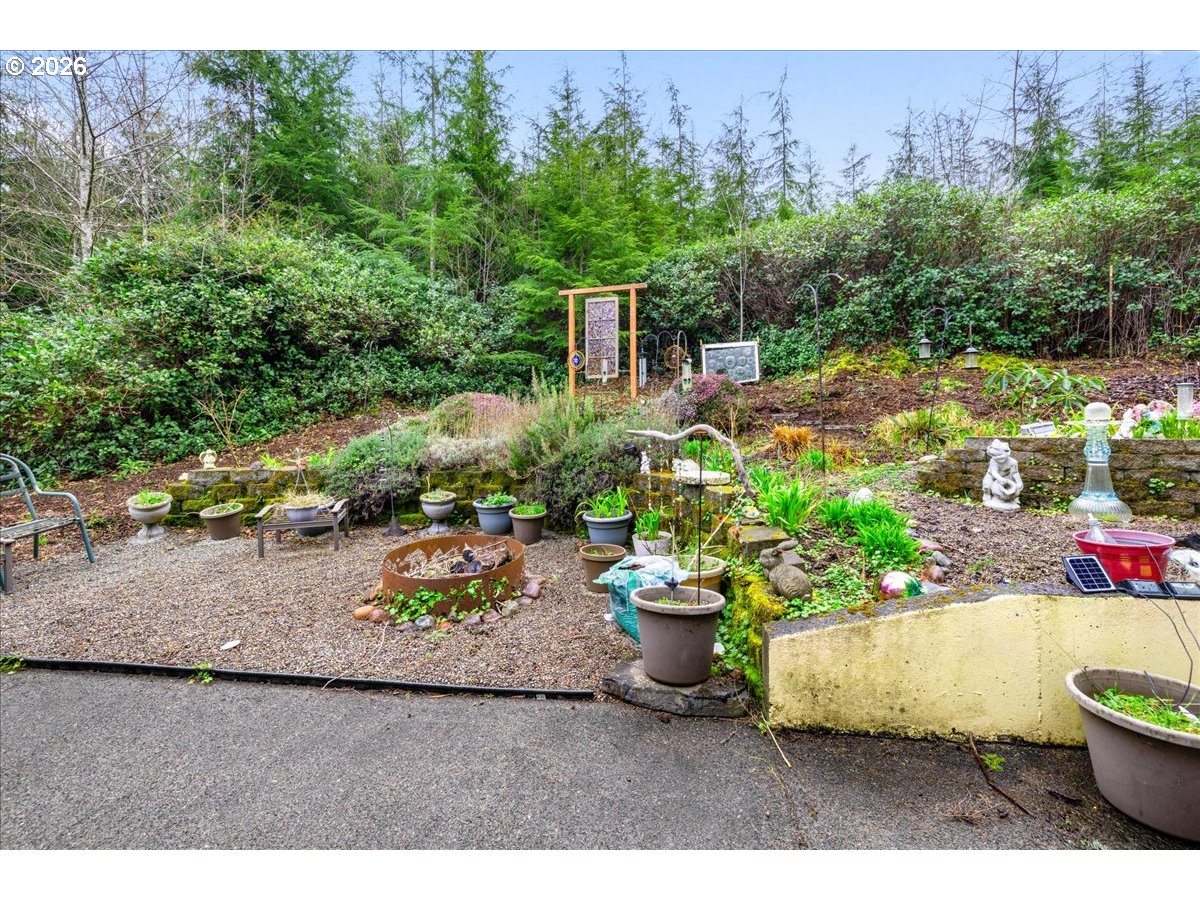 142 South Quadrant Street Rockaway Beach, OR 97136 - Photo 41 of 42 a view of a backyard with plants and outdoor seating
