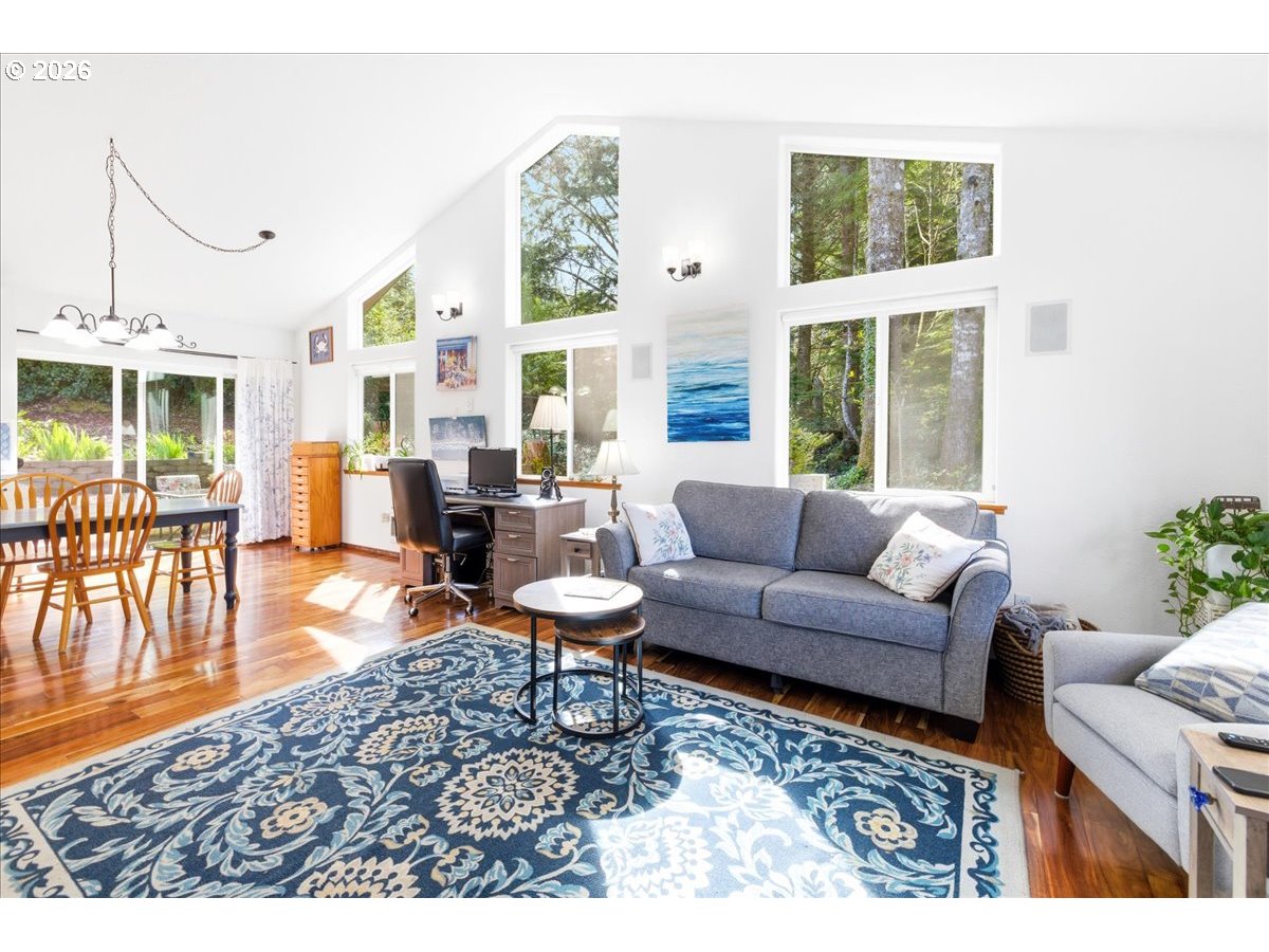 142 South Quadrant Street Rockaway Beach, OR 97136 - Photo 5 of 42 a living room with furniture and a large window