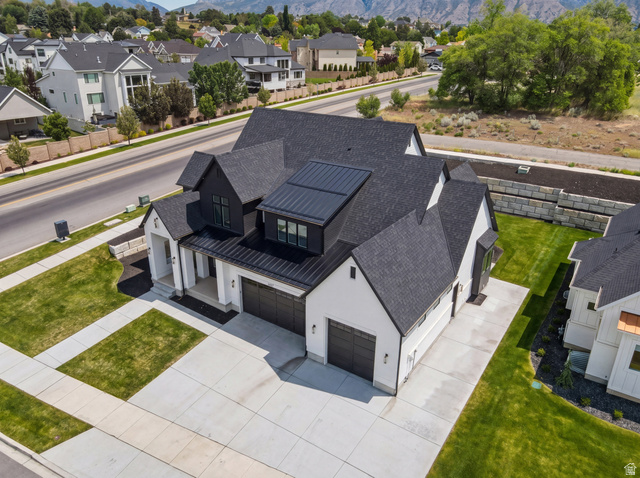 1682 North 1950 W Street, Unit 9 Provo, UT 84604 - Photo 7 of 84 Modern farmhouse exterior featuring a white facade with black trim, multiple gables, and a black shingle roof