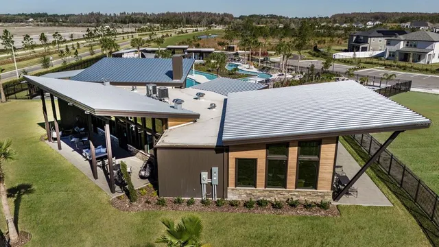 an aerial view of a house with swimming pool and mountains