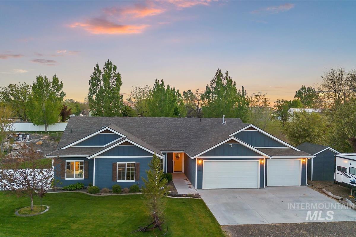 Single-story residence featuring a two-car garage with white doors