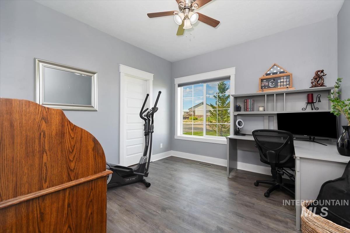 15015 Leon Lane Caldwell, ID 83607 - Photo 28 of 44 Spacious room featuring wood-finish flooring, a contemporary ceiling fan with integrated lighting, and a large window providing ample natural light