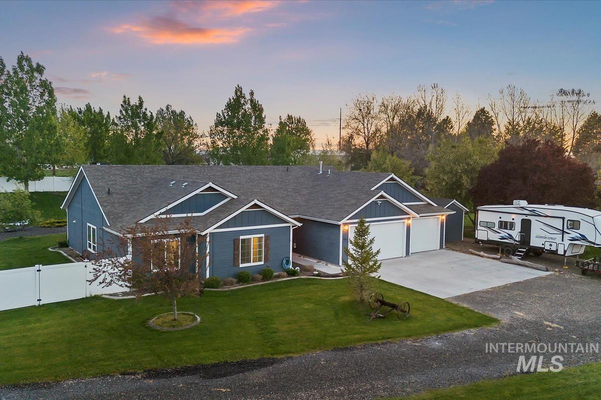 15015 Leon Lane Caldwell, ID 83607 - Photo 38 of 44 Single-story residence featuring a dark gray roofline, dark blue siding, and white trim accents