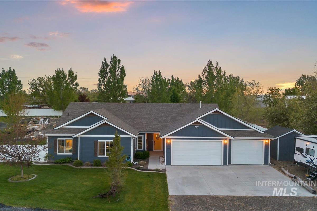 15015 Leon Lane Caldwell, ID 83607 - Photo 41 of 44 Modern craftsman-style residence featuring blue siding with white trim accents and a dark shingle roof
