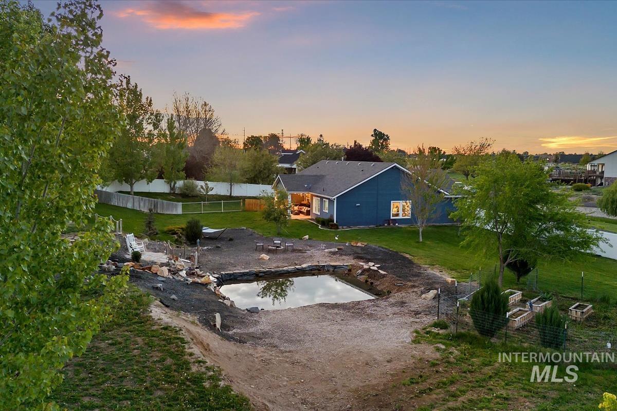 15015 Leon Lane Caldwell, ID 83607 - Photo 42 of 44 Expansive property featuring a large pond, extensive landscaping potential, and a dark blue exterior with white trim