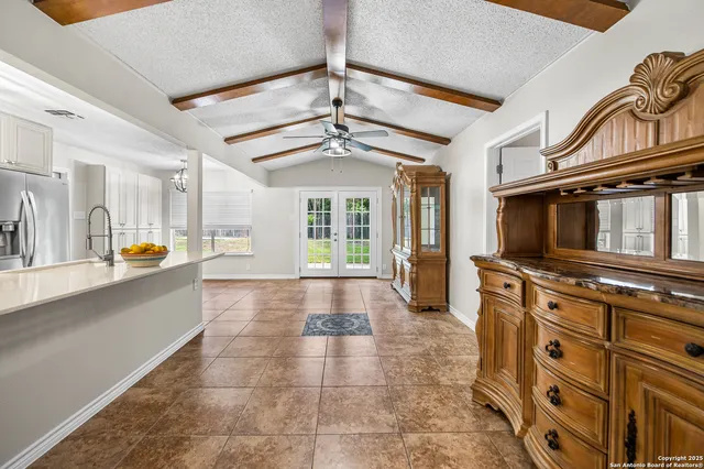 a view of a kitchen with a sink and a refrigerator