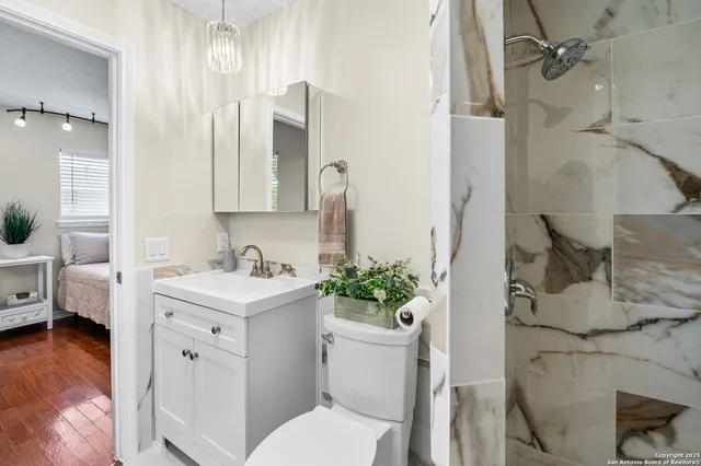 a view of bathroom with a sink toilet and shower