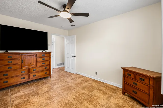 an empty room with furniture and a flat screen tv