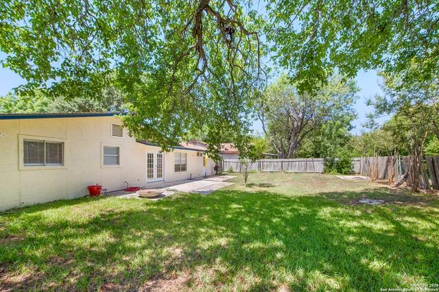 a view of a house with a yard and a garden