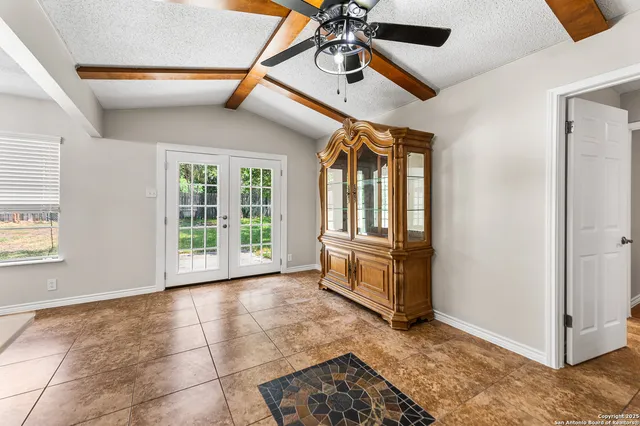 a view of a livingroom with a ceiling fan and window