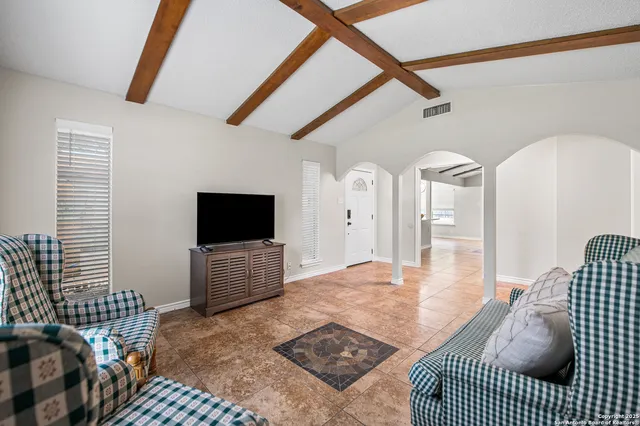 a bedroom with furniture and a flat screen tv