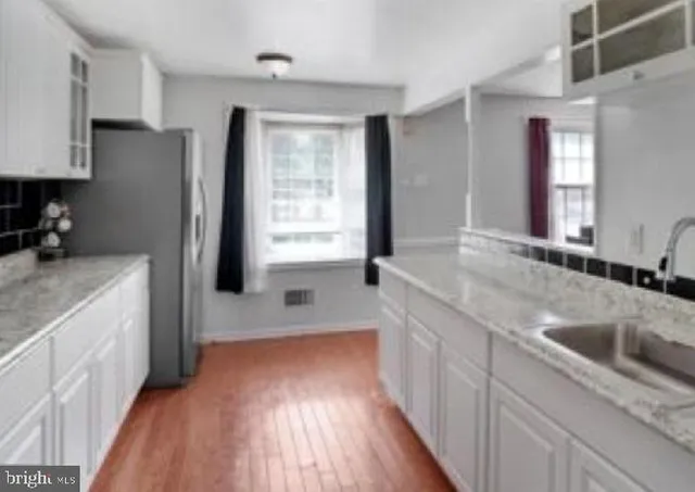 a kitchen with a sink stove and refrigerator