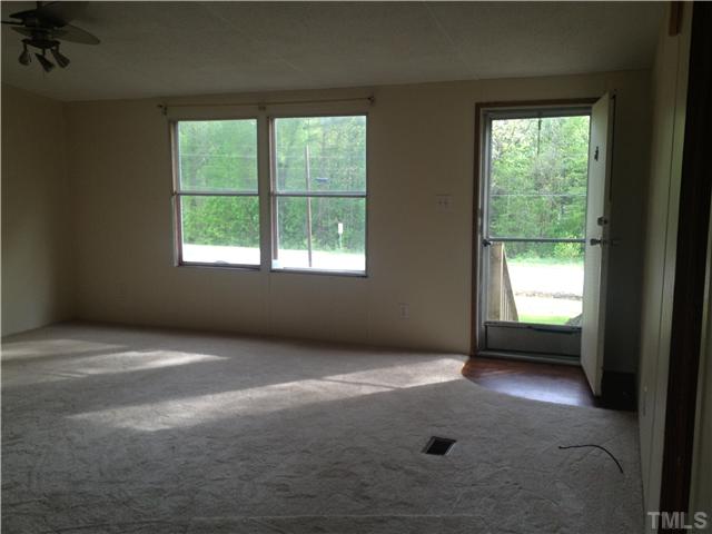 4491 Oxford Road Roxboro, NC 27574 - Photo 4 of 11 an empty room with a window