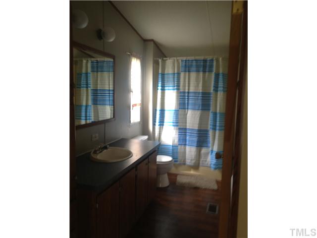 4491 Oxford Road Roxboro, NC 27574 - Photo 6 of 11 a bathroom with a sink and a mirror